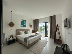 a bedroom with a bed and a television in it at Dreamers Farm in Vinh Thanh +104 photos