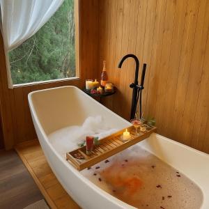 a bath tub with an umbrella and clouds in it at Retro House Mộc Châu in Mộc Châu +120 photos