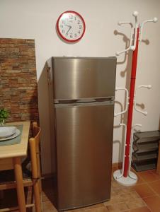 a refrigerator in a kitchen with a clock on the wall at Sunflower in Tavarone +71 photos