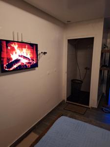 a living room with a flat screen tv on the wall at La Pause Dar Bouazza in Tamaris +1 photo
