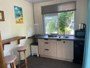 a kitchen with a sink and a window at Kaikea Lodge in Rangiroa