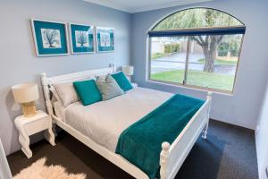 a bedroom with a bed and a window at Aqua Tides - Port Geographe in Geographe +26 photos