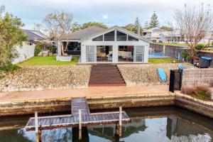 a house on the water with a dock at Aqua Tides - Port Geographe in Geographe