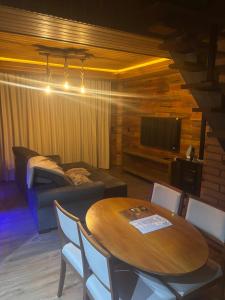 a living room with a table and a couch at Paraíso da Harmonia in Teutônia