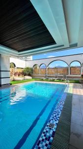 a swimming pool with blue water in a building at Langkawi Seaview Hotel in Kuah +100 photos
