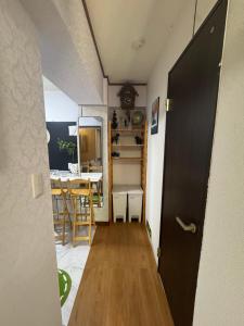 a hallway of a small room with a table and a door at 和風2西北口 in Tokyo