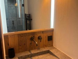 a bathroom with a wooden wall with a faucet at Appartement neuf 7 pers, 3 chambres avec balcon et parking à Val-d'Isère - FR-1-519-43 in Val dʼIsère +13 photos