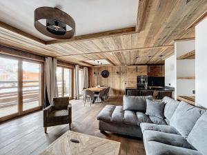 a living room with a couch and a table at Appartement neuf 7 pers, 3 chambres avec balcon et parking à Val-d'Isère - FR-1-519-43 in Val dʼIsère