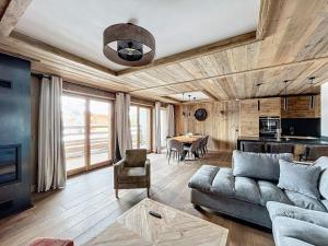 a living room with a couch and a table at Appartement neuf 7 pers, 3 chambres avec balcon et parking à Val-d'Isère - FR-1-519-43 in Val dʼIsère