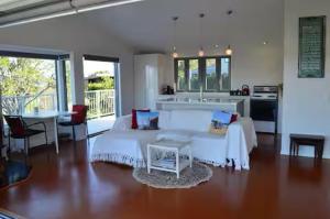 a large room with a bed and a kitchen at Panorama Views Beach Accomodation in Whitianga
