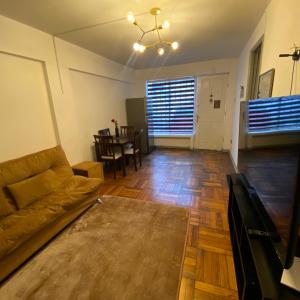 una sala de estar con un sofá y una mesa en CASA ROMÁN Departamento en Providencia para 3 personas, en Santiago