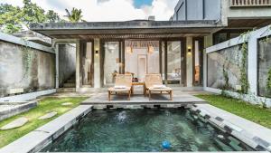 a pool in the backyard of a house at Mawar villa Ubud in Ubud