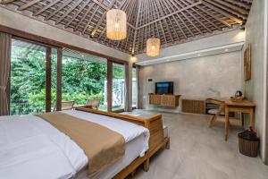 a bedroom with a bed and a tv in it at Mawar villa Ubud in Ubud +71 photos