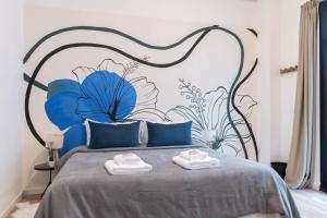 a bedroom with a bed with blue flowers on it at Fliphaus Libertador 6300 - RiverPlate Stadium A in Buenos Aires