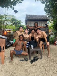 a group of people posing for a picture on the beach at Budal surfing in Legian