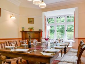 a dining room with a large wooden table with chairs at Ingo Brake Retreat in Okehampton