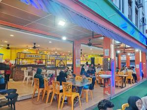 a group of people sitting at tables in a restaurant at Vintage Inn Jonker Walk Melaka in Melaka