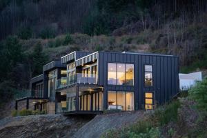 a black house on top of a hill at Sky Villa A in Queenstown