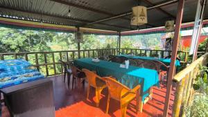 a restaurant with tables and chairs on a balcony at Namaste Home Stay in Dhulikhel