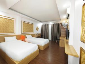 Ένα ή περισσότερα κρεβάτια σε δωμάτιο στο Hanoi Discovery Old Quarter Hotel