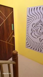 a room with a door and a painting on the wall at Urbania- premium AC PG accommodation for Male in Baranagar