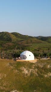 a dome tent on top of a grassy hill at Batanes Glamping  +2 photos