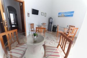 a dining room with a glass table and chairs at Corona Vacanze in Trapani