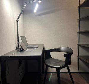 a desk with a chair and a laptop and a lamp at Anbo-ing in Yakushima