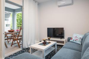 a living room with a couch and a table at Avra Toroni Vacation Home in Toroni