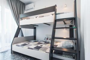 a bunk bed with a ladder in a room at Avra Toroni Vacation Home in Toroni