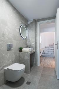 a bathroom with a toilet and a sink and a mirror at Avra Toroni Vacation Home in Toroni +76 photos
