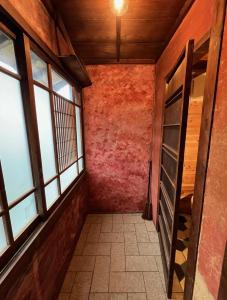 an empty hallway with windows in a building at 坂東商店guest room藍染めと宿 in Wada +7 photos