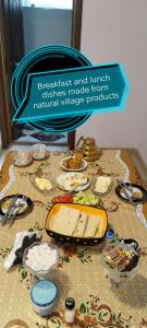 a table topped with different types of cheese on it at Xinaliq Khinalig ELNUR GUEST HOUSE, New hotel in Xınalıq