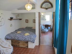 a bedroom with a bed and a living room at B&B Sul Cammino in Dolcedo