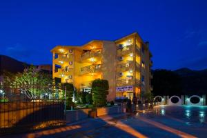 a large building at night with lights on at Apartments Radević in Budva