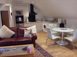 a living room with a couch and a table at The BurnHowf apartment in Balloch