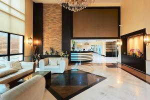 a living room with couches and a chandelier at 42Grand Residence in Bangkok