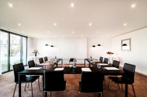 a large meeting room with a long table and chairs at L'Agapa Hôtel - Spa Codage in Perros-Guirec