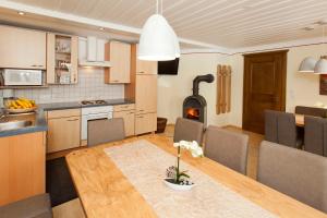a kitchen and dining room with a table and a fireplace at Alte Schmiede in Nauders