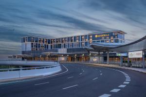 a large building with a road in front of it at Traders Hongqiao Airport,Shanghai in Shanghai