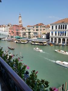 a river with boats in a city with buildings at Antica Locanda Sturion Residenza d'Epoca in Venice