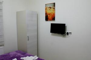 a bedroom with a bed and a tv on a wall at Hotel Baris in Istanbul