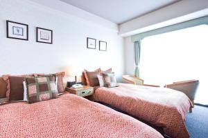 Postel nebo postele na pokoji v ubytování Hotel Villa Kuretake