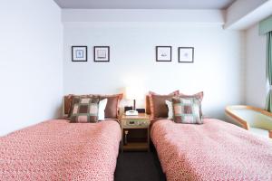 Postel nebo postele na pokoji v ubytování Hotel Villa Kuretake