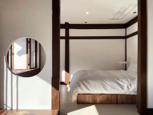 a bedroom with a bed and a mirror at Hanok Stay - Ladam in Jeonju
