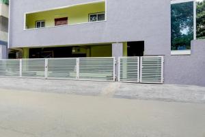 a building with a fence in front of it at Collection O Tirupati Railway Junction Formerly Y Stay Home Stay in Tirupati