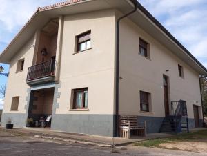a large white building with a balcony on the side at Abaunza enea in Erenchun