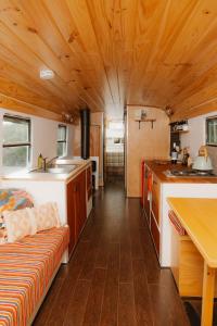 a kitchen and living room of a tiny house at R&R Bus Retreat in Wellington Mills