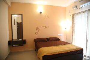 a bedroom with a bed and a large mirror at Beachside Bliss - Villa 32 in Kilpettai
