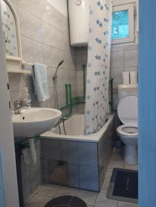 a bathroom with a sink and a tub and a toilet at Vikendica Mia Balkana in Mrkonjić Grad +26 photos